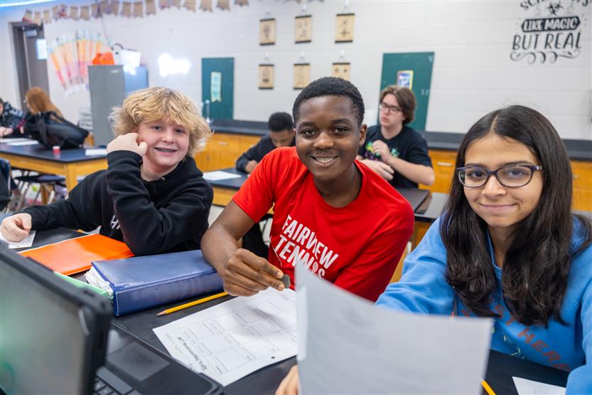 Students study rocks in a science lab
